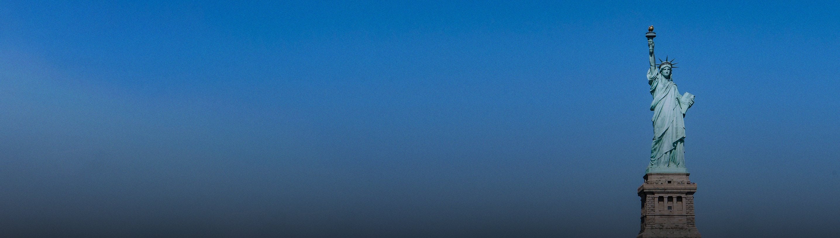The Statue of Liberty against a clear blue sky